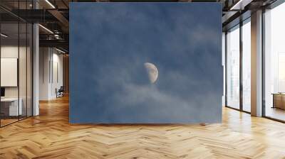 Moon in the dark blue sky with white clouds, natural background. Wall mural