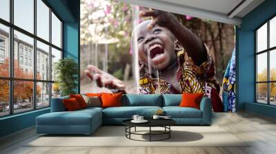 Incredibly Happy African Child Enjoying the Rain as a Water Scarcity Symbol Wall mural