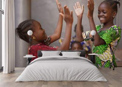 Two Little African Girls Performing A Hand Clapping Game Wall mural