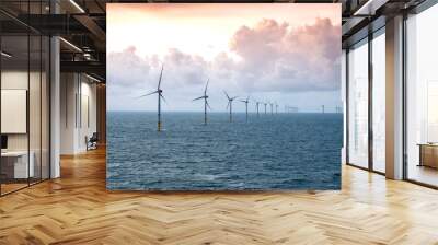 Sunset over offshore wind farm - green power generation Wall mural