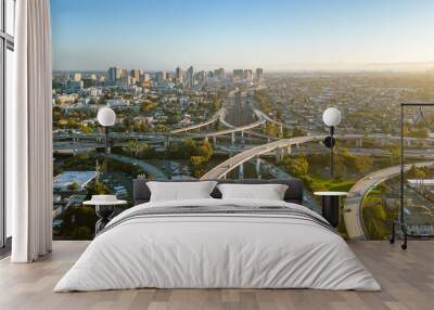 A drone view over the freeway cypress in Oakland, California during sunset with the downtown in the background. Wall mural