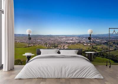 Aerial photos over the Dublin Hills in Dublin, California with a city in the background with a blue sky Wall mural