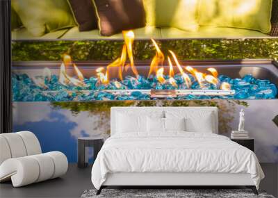 Glass Fire Table next to patio furniture and with a tree reflection on the glass Wall mural