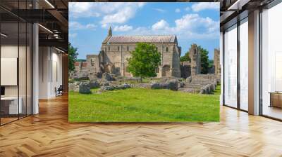 Side view of The Priory Church of St Mary and the Holy Cross situated within the ruins of Binham Priory in Binham, North Norfolk, UK Wall mural