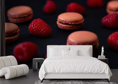 macaroons of different colors on a black background Wall mural