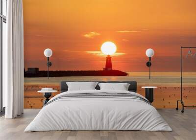 Sun rising directly behind Poolbeg lighthouse in Dublin, Ireland Wall mural