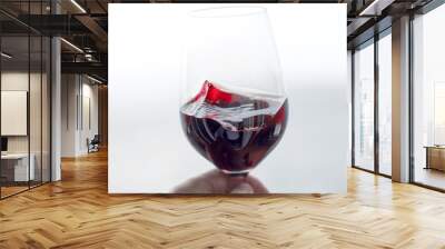 Swirling red wine close up on light background Wall mural