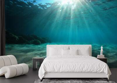 underwater background deep blue sea and beautiful light rays with sandy floor Wall mural