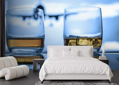 Whiskey neat and on ice close up view on reflective surface at the airport with airplane in the air. Wall mural