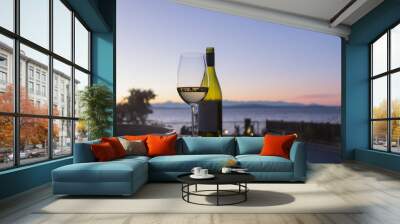 White wine outside hero shot with bottle at golden hour sunset. Wall mural