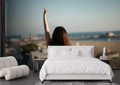 Young woman overlooking on hill overlooking Santa Monica Beach Wall mural