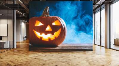 halloween banner with glowing pumpkin on a wooden table fog or smoke in the background blue light Wall mural