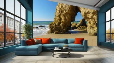 A ocean view with a rock formation and blue skies at El Matador Beach in Malibu California. Wall mural