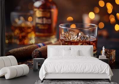 A glass of bourbon whiskey with ice cubes sits on a table next to two cigars, creating a sophisticated and luxurious atmosphere Wall mural