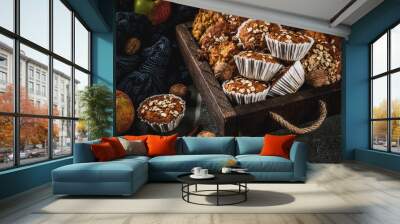 Autumn winter pastries. Vegan food. Healthy homemade baking cookies, muffins with nuts, apples, oat flakes. Cozy home atmosphere, warm blanket, ingredients for baking. Dark stone table. Copy space Wall mural