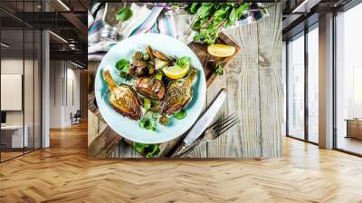 Cooked baked artichoke, alla romana, grilled artichoke flowers with olive oil, lemon, garlic, mint  and spices. Copy space Wall mural