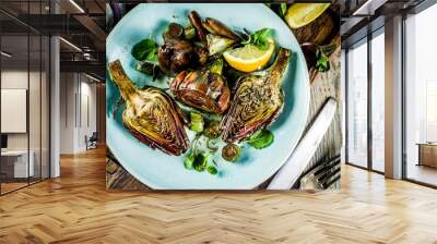 Cooked baked artichoke, alla romana, grilled artichoke flowers with olive oil, lemon, garlic, mint  and spices. Copy space Wall mural