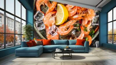 Fresh raw seafood squid shrimp oyster mussels fish with spices of herbs lemon on dark rusty background copy space top view Wall mural