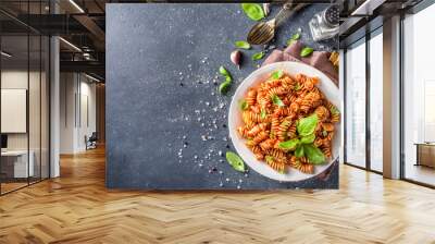 Fusilli pasta with tomato sauce and basil. Traditional italian Fusilli pasta marinara, on dark background copy space Wall mural