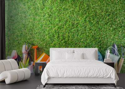 Gardening tools and flowers on the terrace and green grass in garden, Concept of spring gardening hobby copy space Wall mural