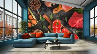 Healthy food background. Selection of protein sources: beef and pork meat, chicken  filet, salmon fish, egg, beans, nuts, milk. Top view copy space, dark background Wall mural