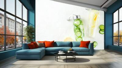 Organic summer cold refreshing drink, detox infused water, with lemon fruit and cucumber vegetables. Vegan lifestyle, weight loss and fitness. On a light wooden background, copy space Wall mural