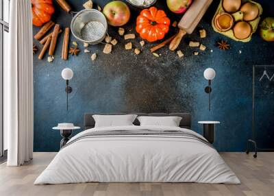 Sweet autumn baking concept, cooking background with baking accessories, flour, rolling pin, decorative pumpkins, apples, cinnamon spices with anise cardamom sugar.  Wall mural