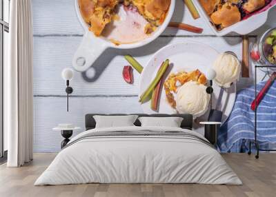 Sweet rhubarb berry cobbler pie, homemade sponge cake with sugared rhubarb and strawberry, served with vanilla ice cream ball, on sunny white wooden kitchen table Wall mural