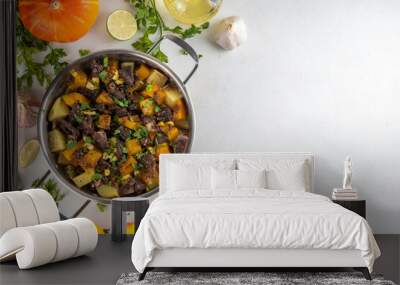 Warm pumpkin stew with potato and beef meat, comfort autumn dinner balanced food, with ingredients on kitchen table Wall mural