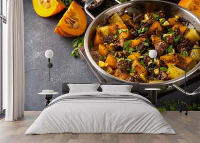 Warm pumpkin stew with potato and beef meat, comfort autumn dinner balanced food, with ingredients on kitchen table Wall mural