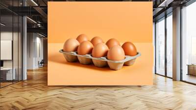 8 farm fresh brown eggs in carton isolated on plain yellow studio background Wall mural