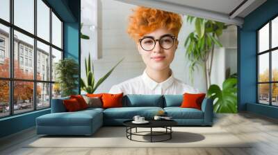 cool young person with orange dyed short hair wearing white shirt glasses portrait in modern office, diversity  Wall mural