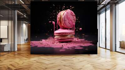 two pink macarons with pink splash energetic food editorial design on black background Wall mural