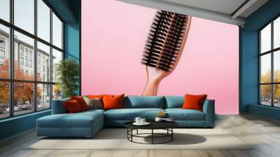 wooden hairbrush isolated on pink studio background, made with generative ai Wall mural