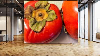 Two persimmons isolated on white background Wall mural