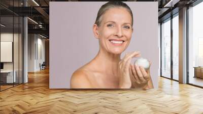  Woman holding jar of moisturizer Wall mural