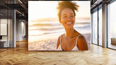 African young woman relaxing at beach during sunset Wall mural