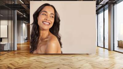 Beautiful young woman laughing after beauty treatment at spa Wall mural