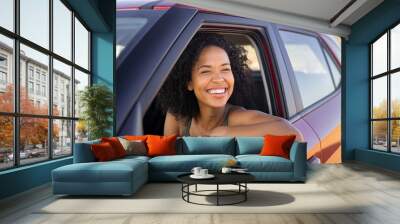 Black young woman looking outside car Wall mural