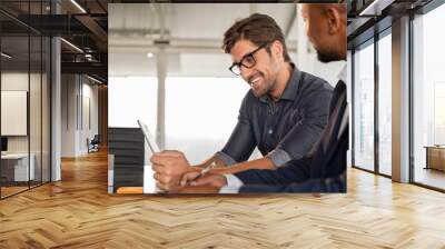 Businessmen working together at desk Wall mural