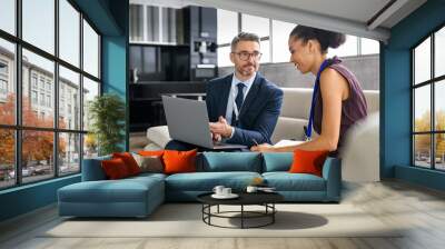 Businesspeople working on laptop during  business meeting Wall mural