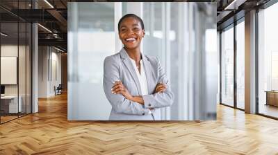 Cheerful mid adult business woman smiling at office Wall mural