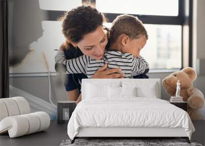 Cute child hugging nurse at hospital Wall mural