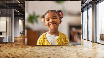 Cute little african american girl looking at camera Wall mural