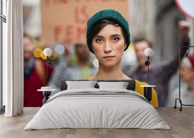 Determined young woman in protest Wall mural