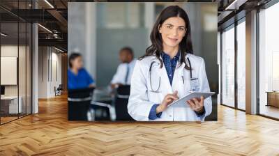 Doctor holding digital tablet at meeting room Wall mural