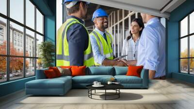 Engineer and businessman handshake at construction site Wall mural