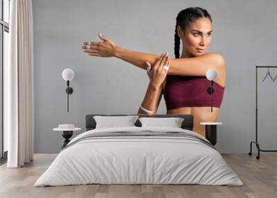 Fit mid woman doing stretching Wall mural