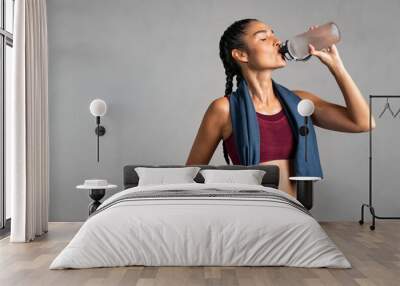 Fit woman drinking from water bottle Wall mural