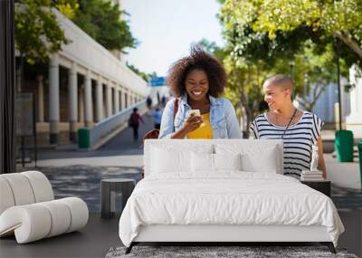 Friends using phone together Wall mural